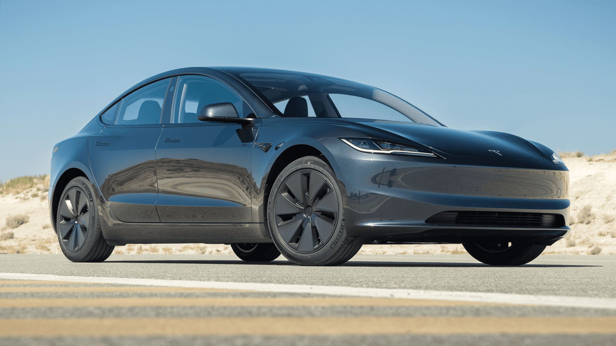 Tesla car on road with blue sky