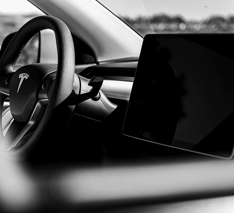 Interior of Tesla Model Y, focusing on steering wheel and display